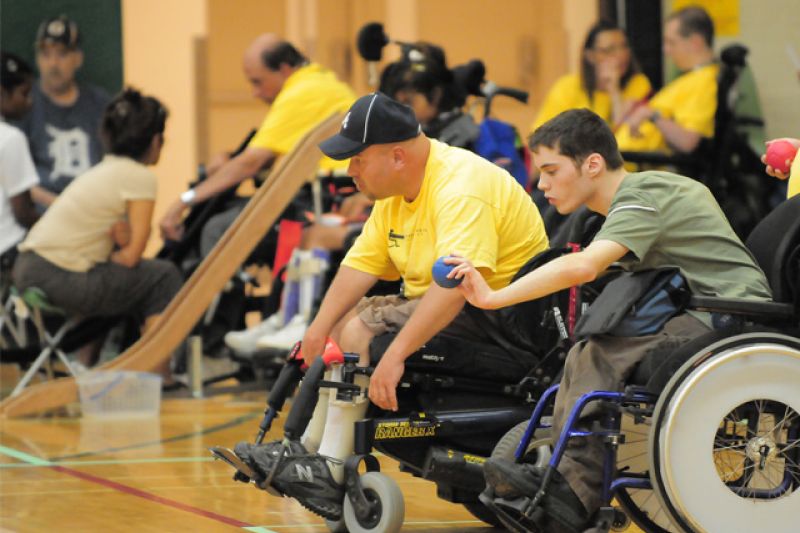 two players in wheelchairs tossing boccia balls.