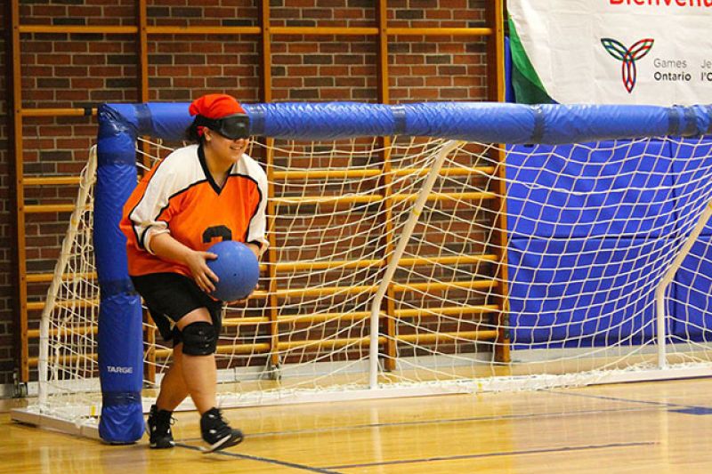 goalball player holding ball standing in the net